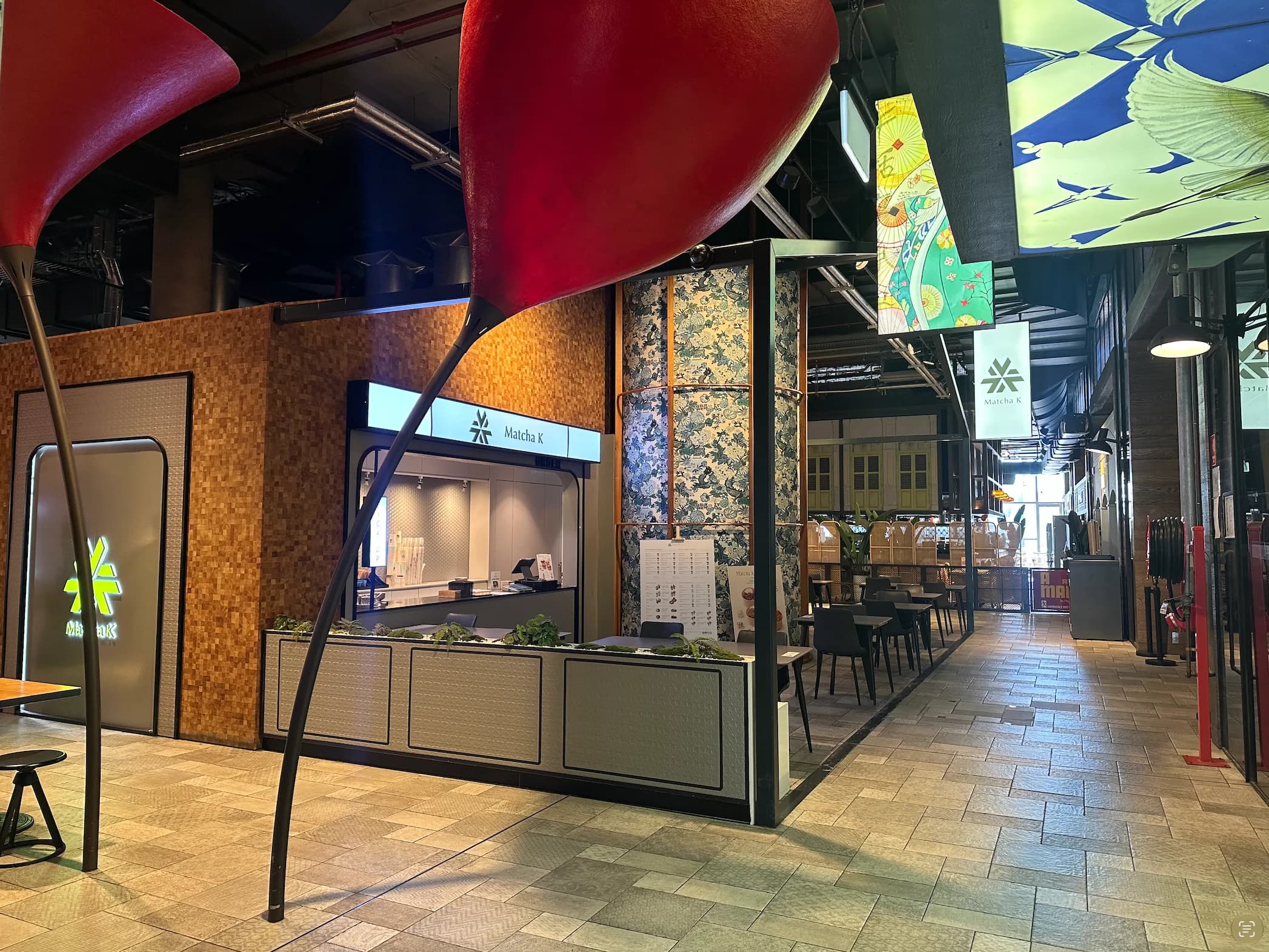 Restaurant fronts beneath red ceiling sculptures at District Dining, Chatswood